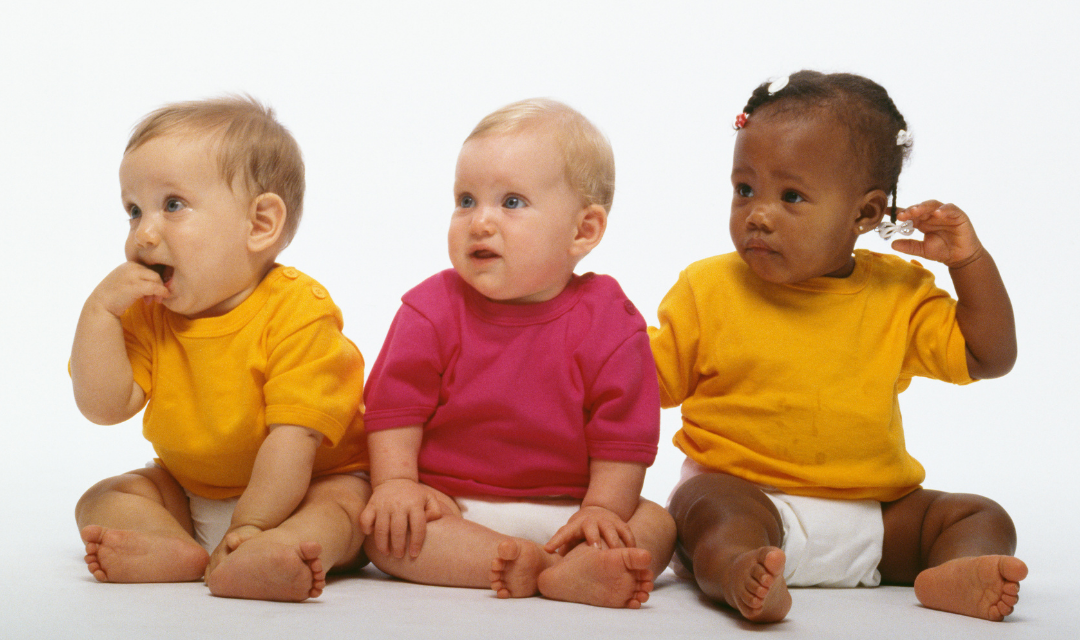 Three babies lined up for a photo