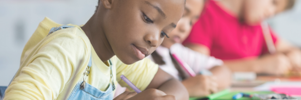 school age child doing work at child care program