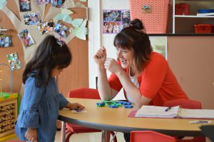 Teacher and student at a table.