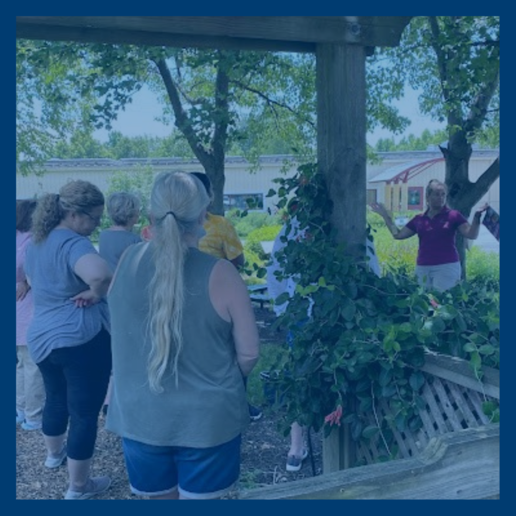 People stand around a garden