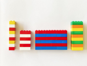 image of four lego structures with color patterns. An example to demonstrate how children can incorporate math concepts in fine motor toys. 