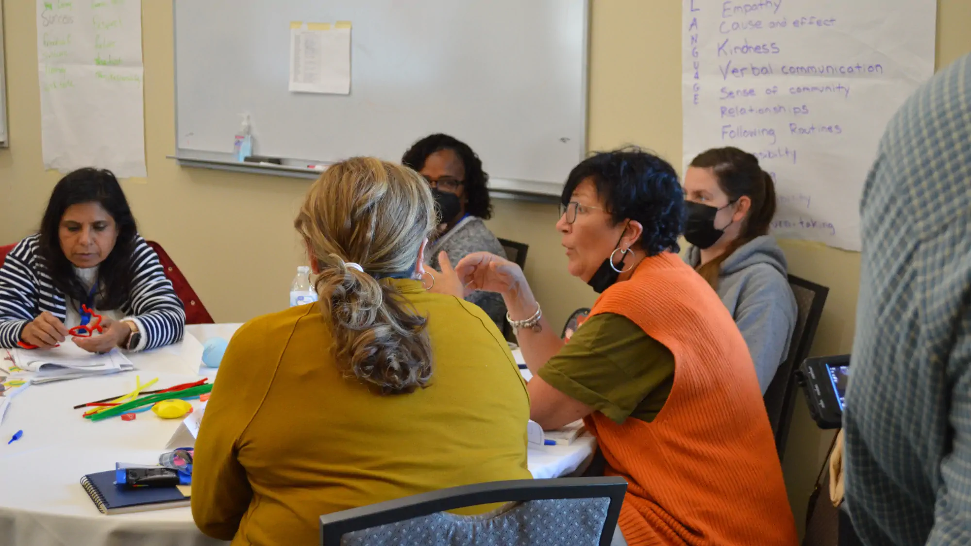 First State Family Child Care participants have discussion at a table.