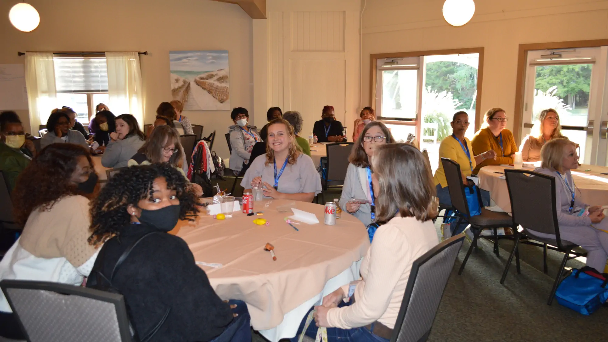 Attendees seated at a circular table at the First State Famliy Child Care Conference.
