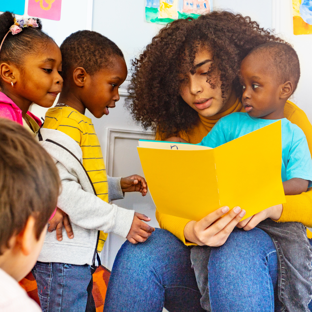 Teacher surrounded by a group of engaged children, it highlights the importance of active and appropriate supervision to ensure child safety and attendance tracking in child care settings.