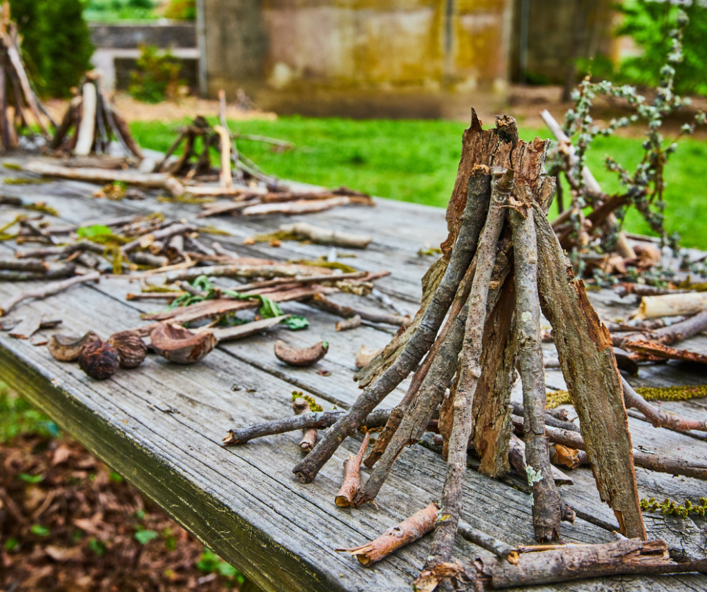 Image of picnic table covered in small stick piles.