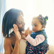 A mother and child doing a high-five